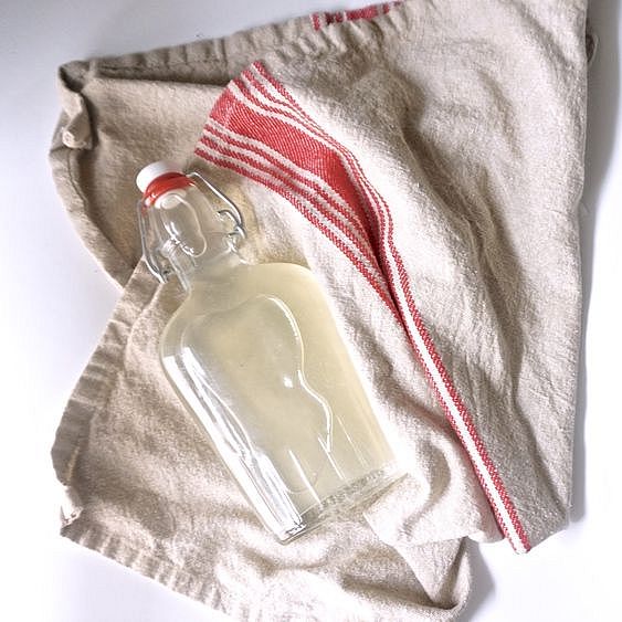 Jug of mouthwash laying on a dishtowel