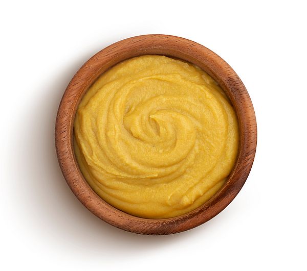 wooden bowl filled with mustard
